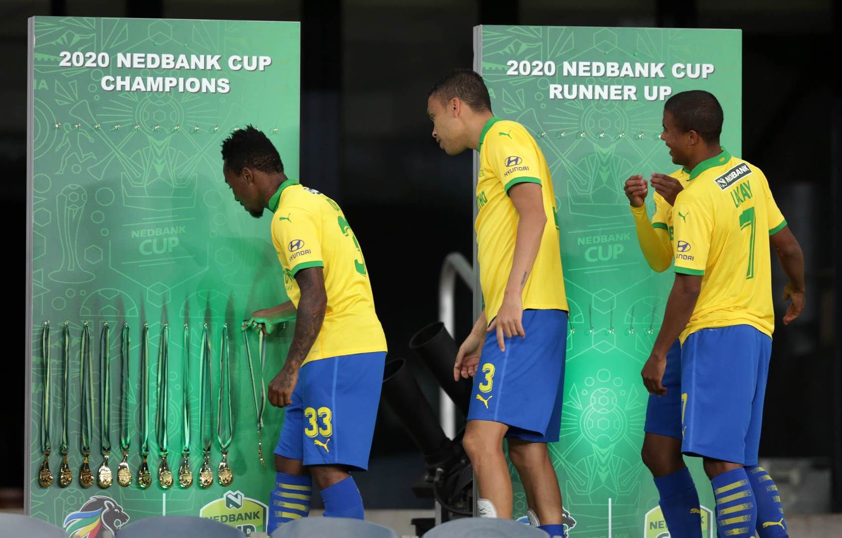 Mamelodi Sundowns players collecting winners medal