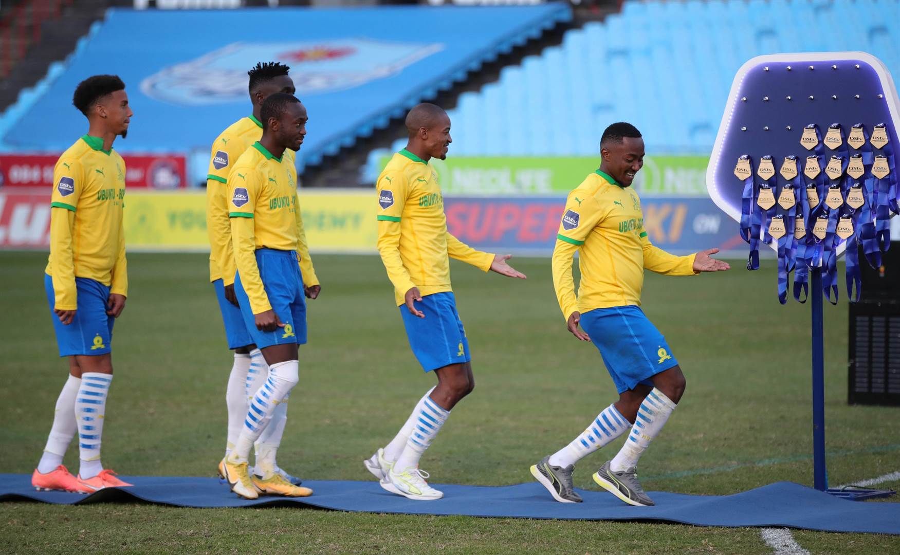 Sundowns players collect their gold medals. Image 